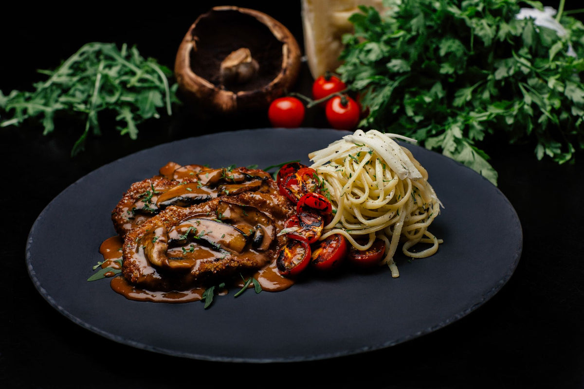 Escalope de veau à la crème et aux champignons, servie avec des pâtes